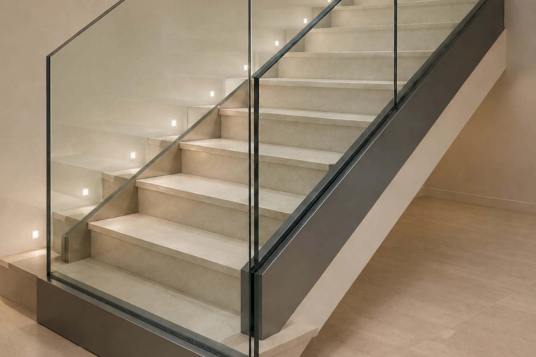 Frameless glass railing along an illuminated staircase edge